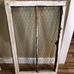 Wooden window frame with chicken wire